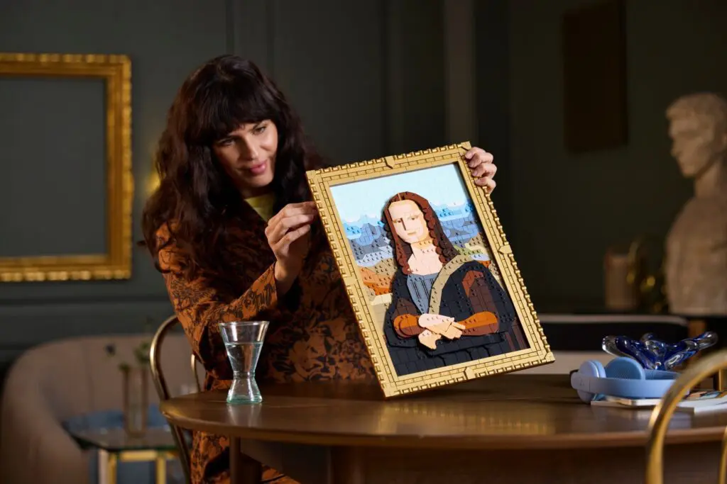 Woman showing handmade Mona Lisa artwork.