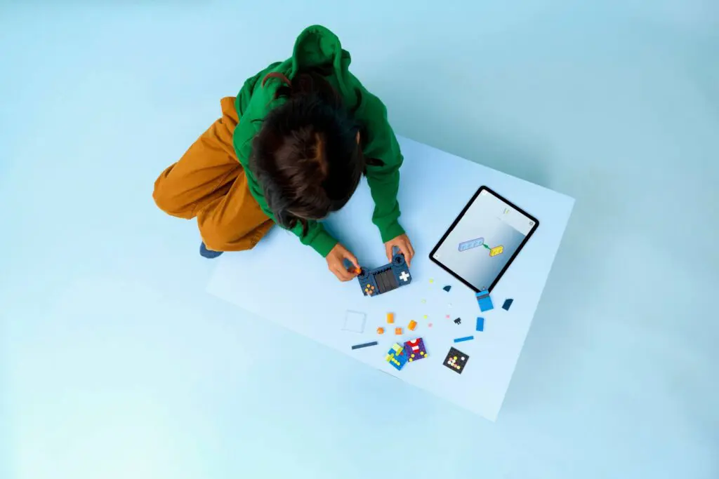Boy playing with colorful puzzle and tablet