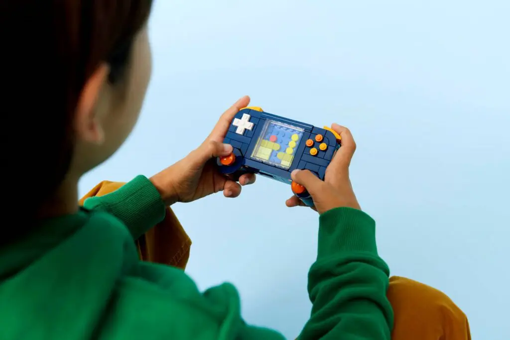 Person playing handheld retro game console