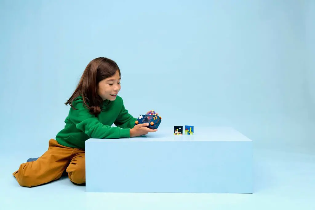 Child playing with colorful toy blocks