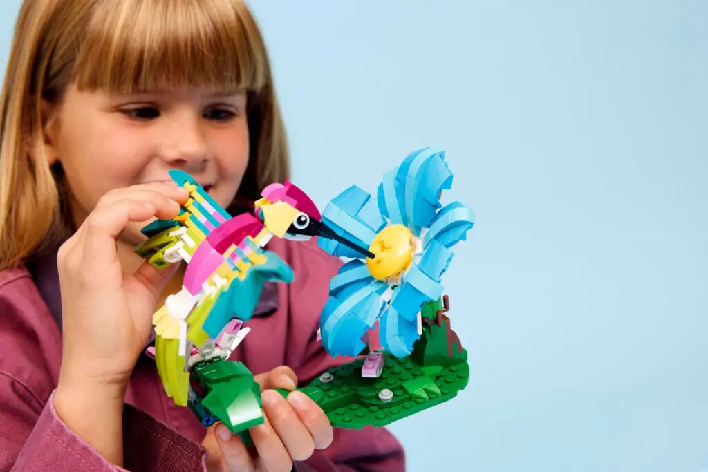 Child playing with LEGO bird and flower