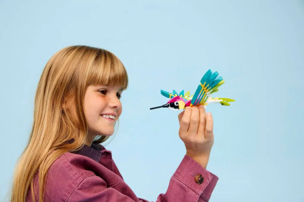 Girl holding colorful toy bird