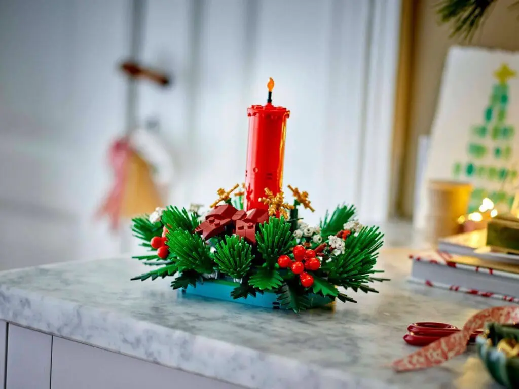 Festive candle centerpiece with greenery