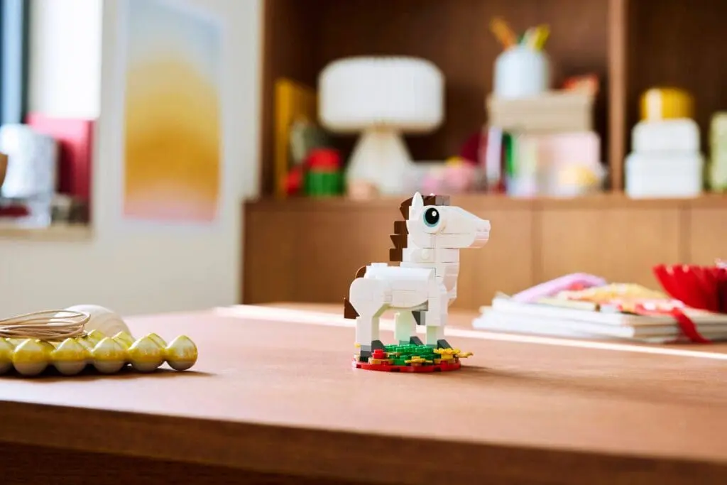 Toy horse made of bricks on table