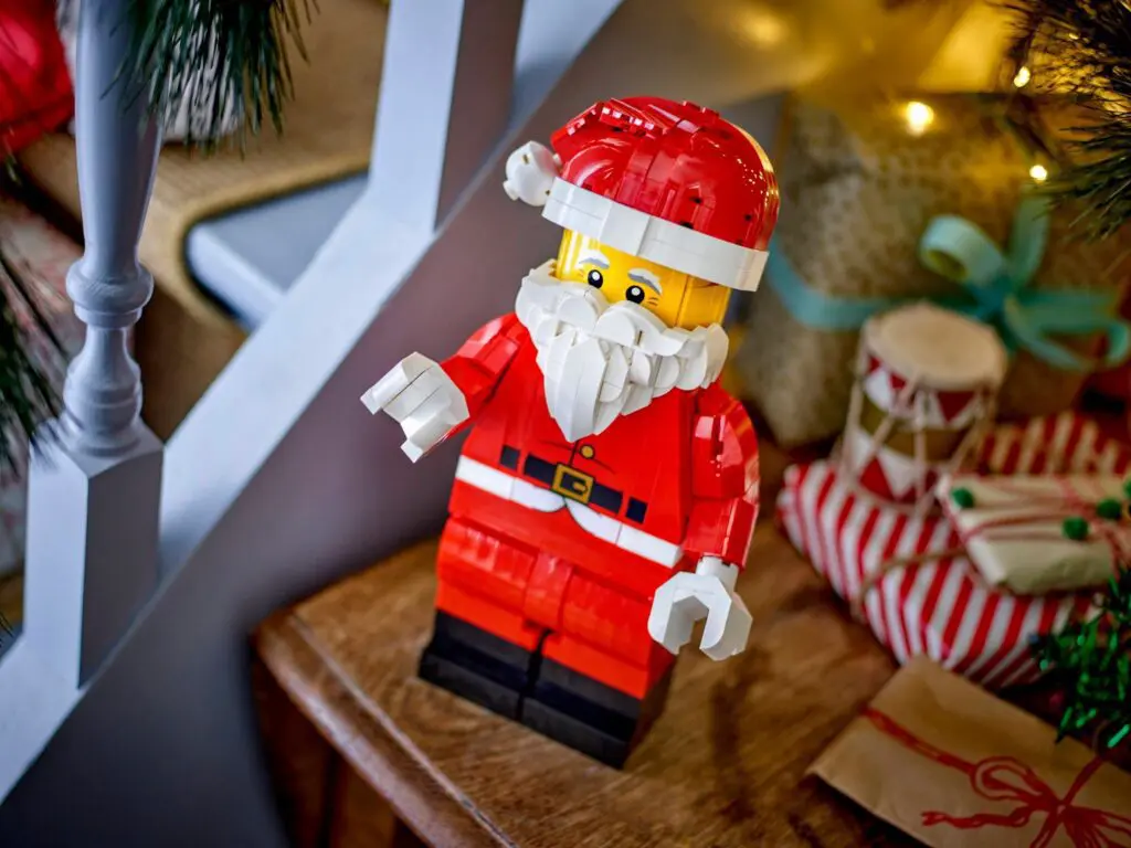 Festive LEGO Santa next to wrapped gifts