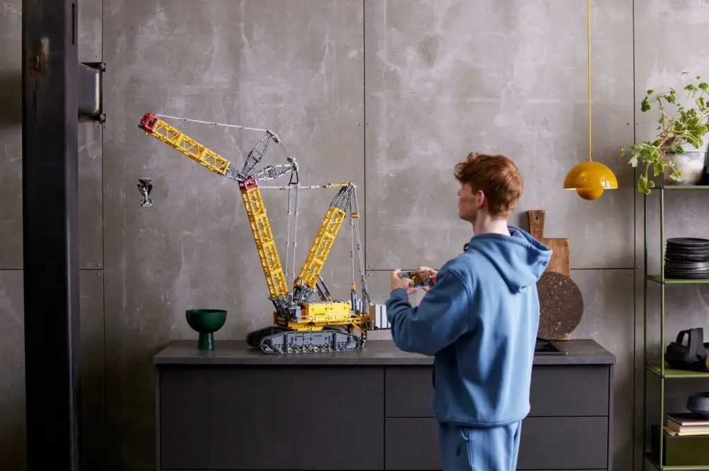 Individual constructing a large crane model