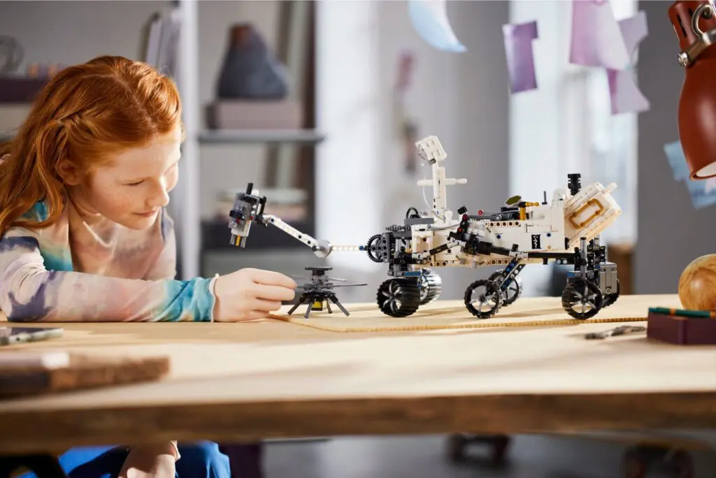 Kid exploring space-themed toy on table