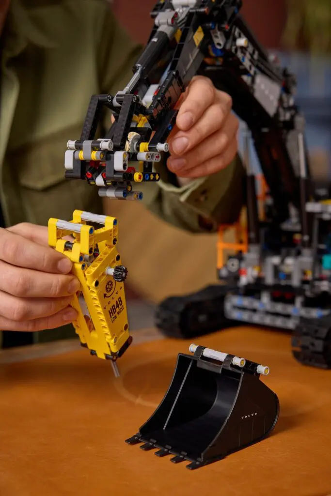 Hands assembling a construction toy