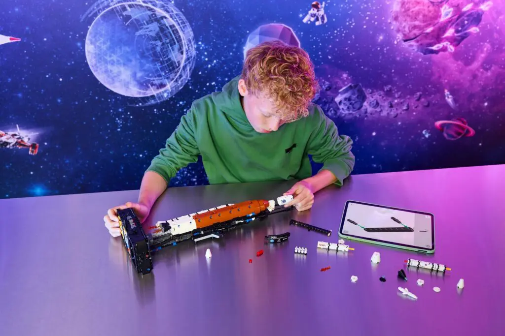 Boy constructing space-themed model