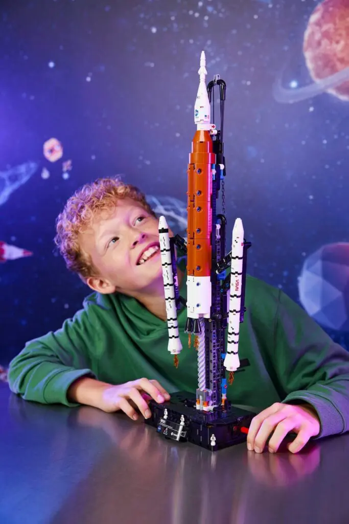 Boy with space-themed toy rocket