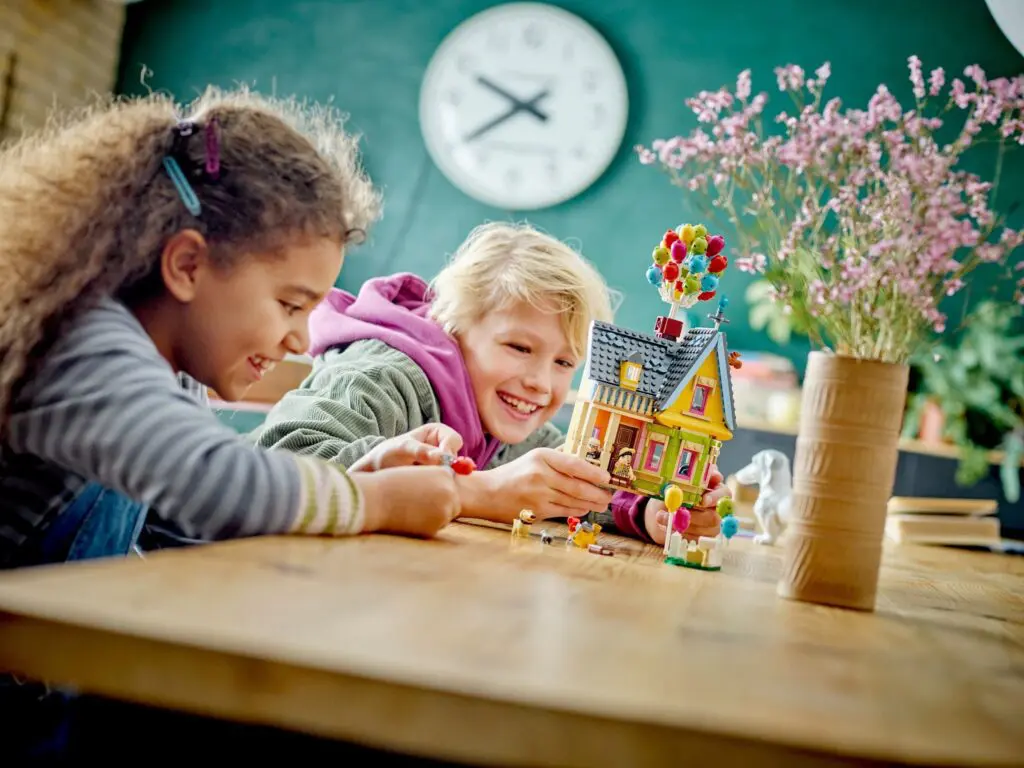 Children playing with colorful house toy