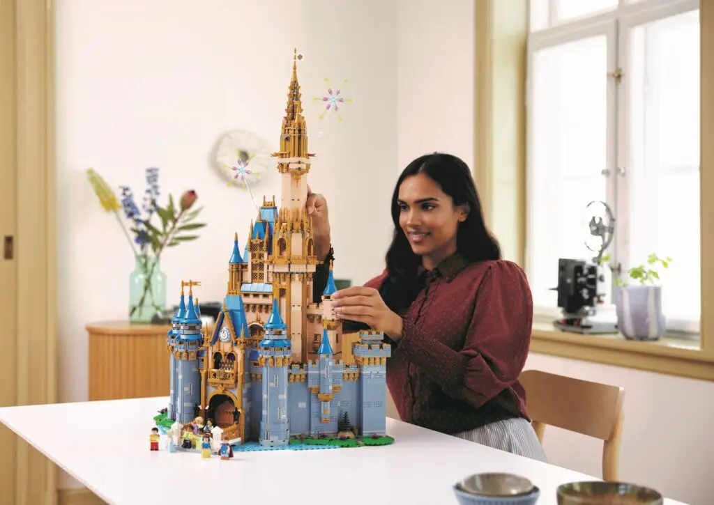 Person crafting elaborate castle set