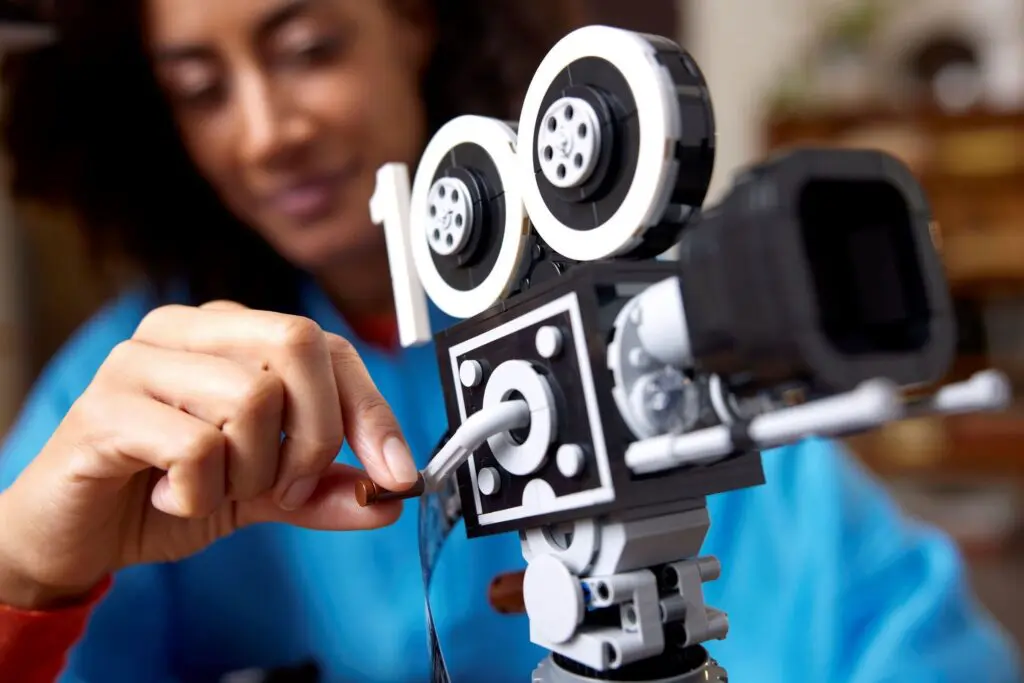 Close-up of hands building camera model
