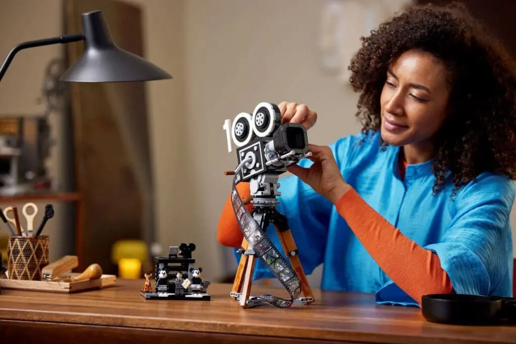 Woman assembling a vintage film camera model