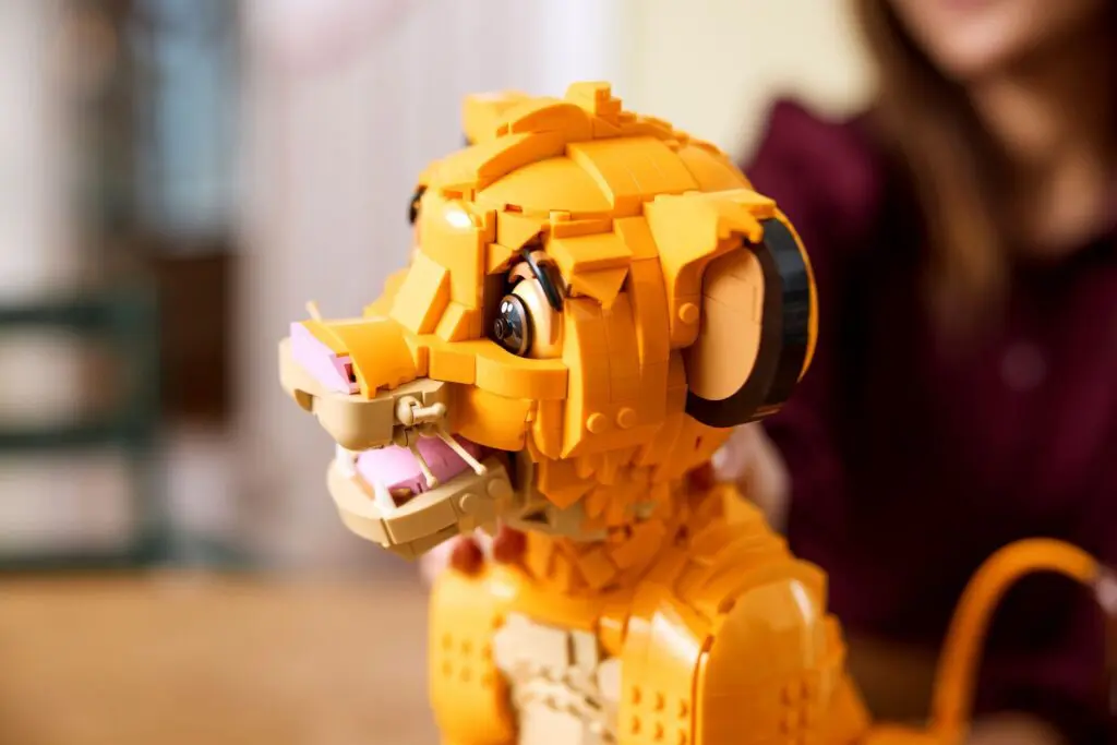 Person assembling LEGO lion set