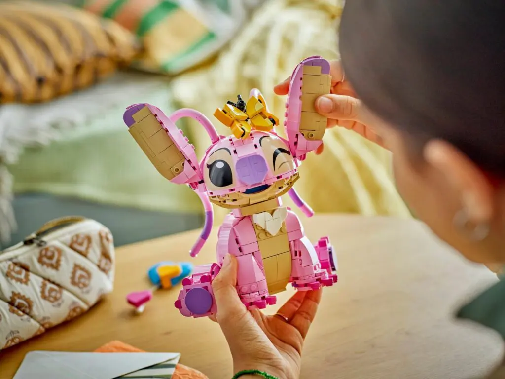 Person building a pink toy figure