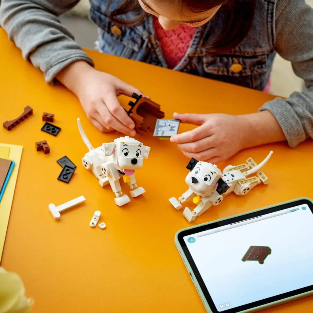 Girl assembling LEGO animals on table