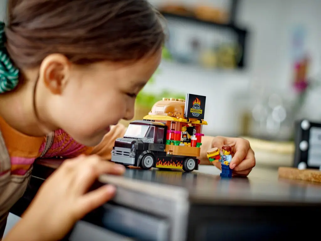 Little girl with colorful toy vehicle