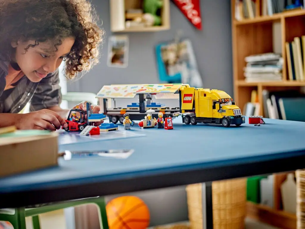 Child playing with LEGO truck set