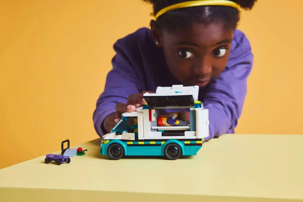 Young girl engaged with toy vehicle.