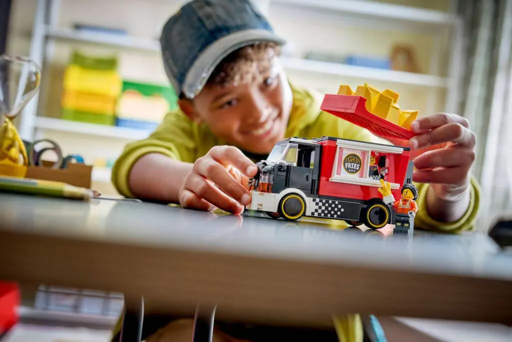 Child playing with toy food truck