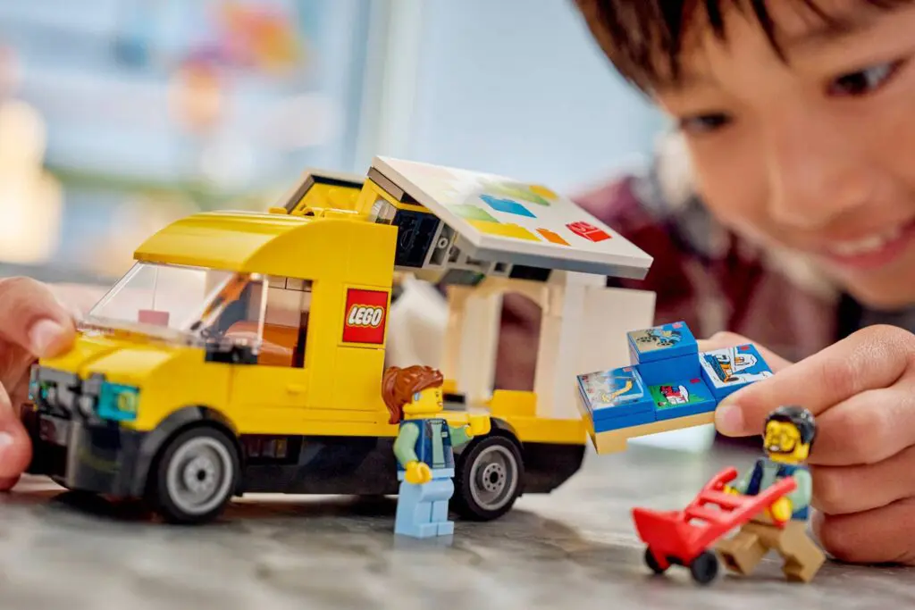 Child playing with LEGO ice cream truck set