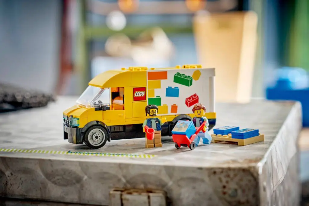 Colorful LEGO set with people and vehicle.