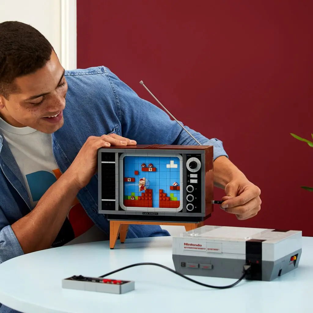Man playing with retro gaming console