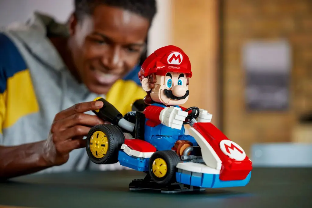 Person playing with Mario Kart toy