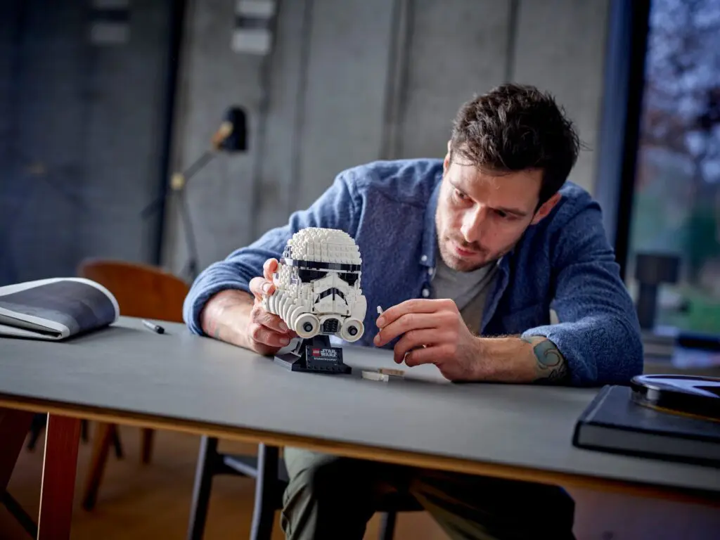 Man assembling LEGO Stormtrooper helmet