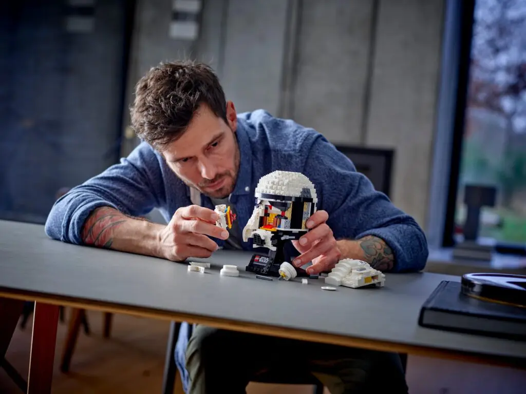 Person building LEGO set at table
