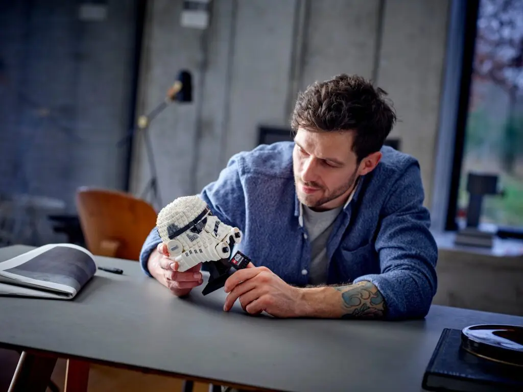 Man examining a LEGO Stormtrooper helmet
