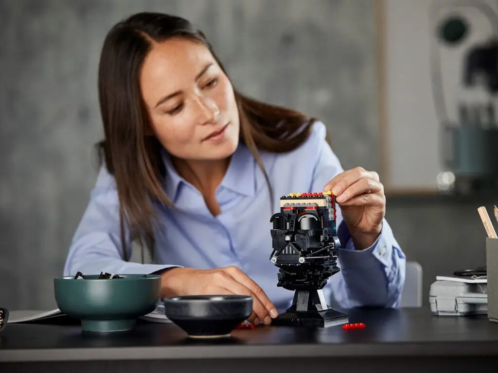 Woman crafting with LEGO pieces indoors