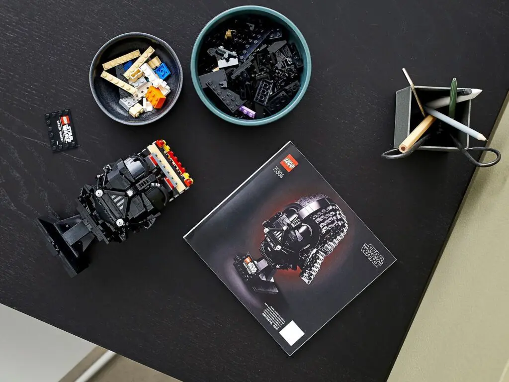 LEGO building pieces and booklet on desk
