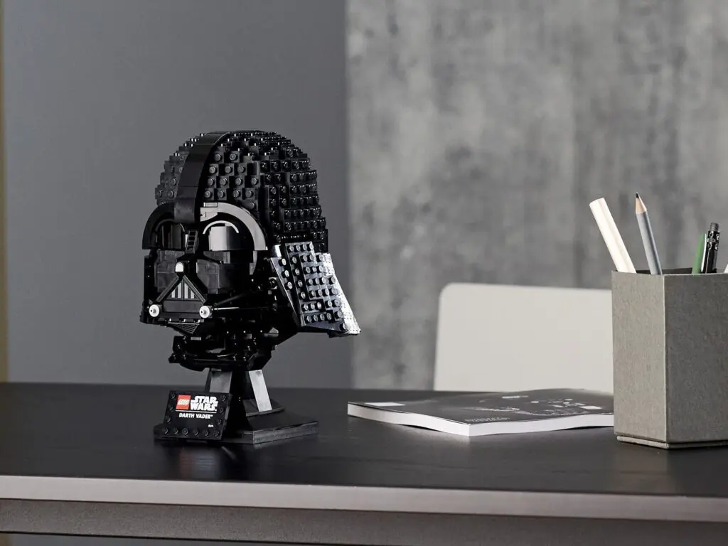 Darth Vader LEGO model beside notebook