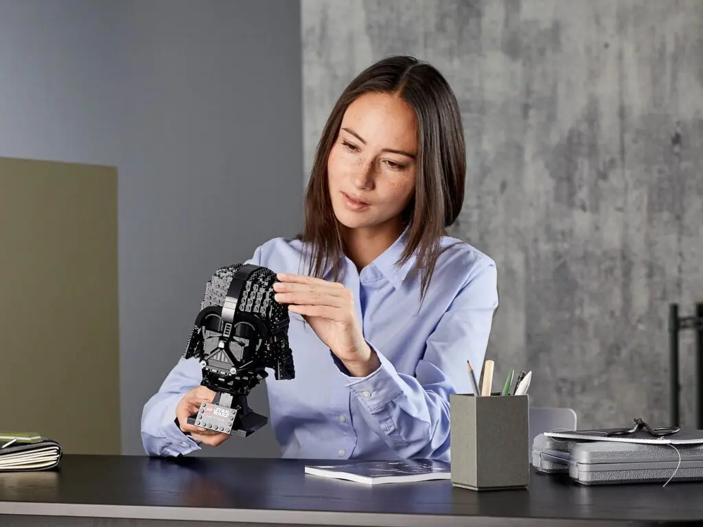 Woman assembling a black helmet model