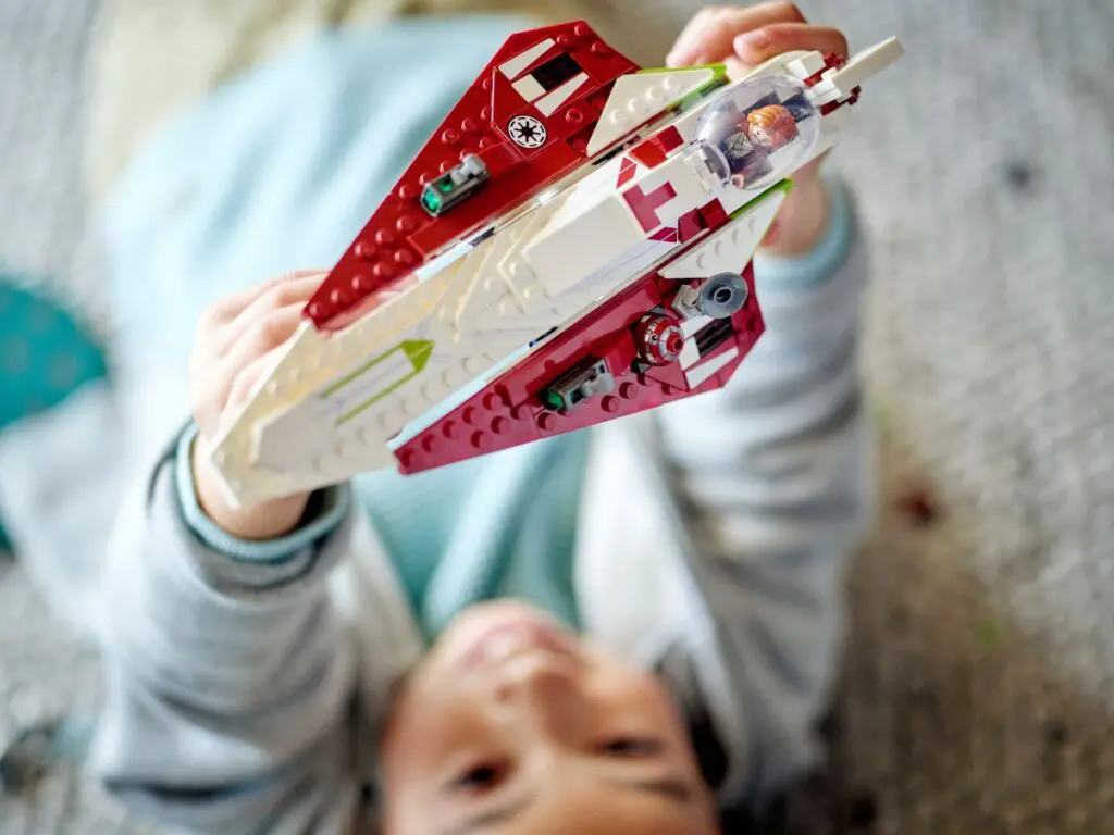 Child playing with a toy spaceship