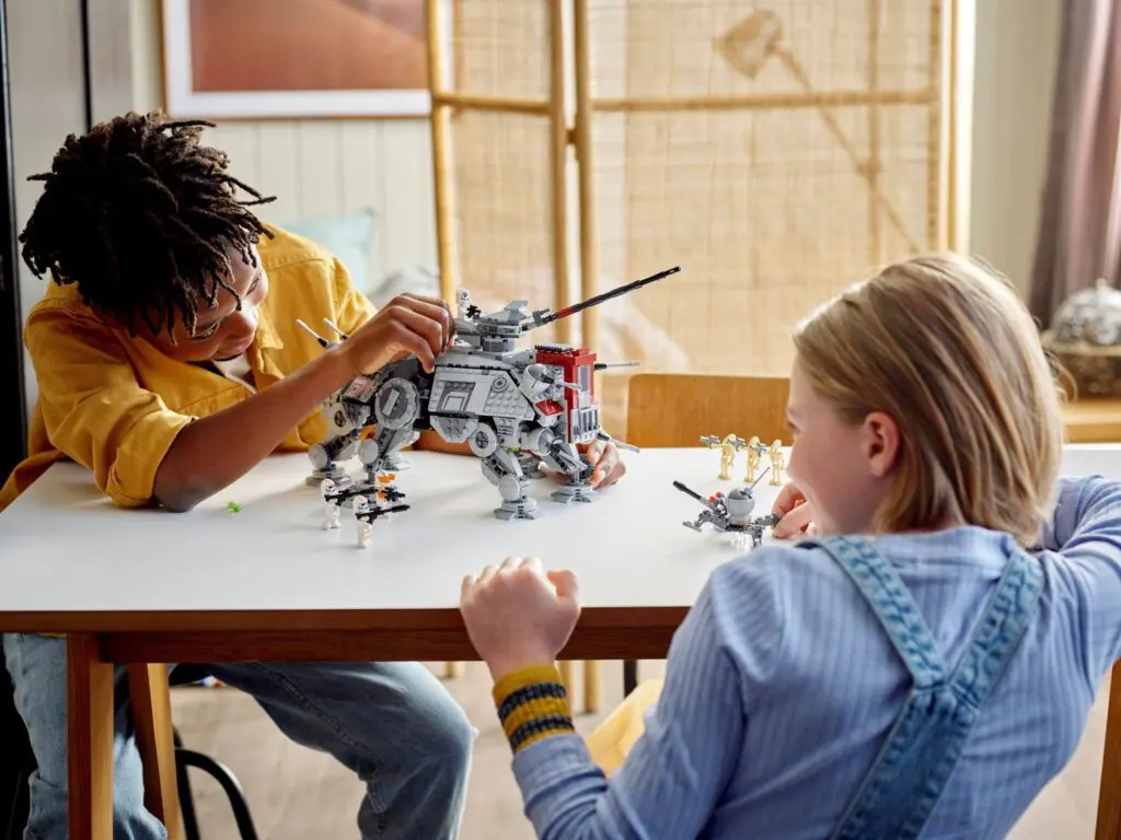 Kids assembling a mechanical model on table