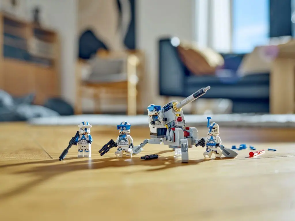 Toy soldiers and vehicle on wooden floor
