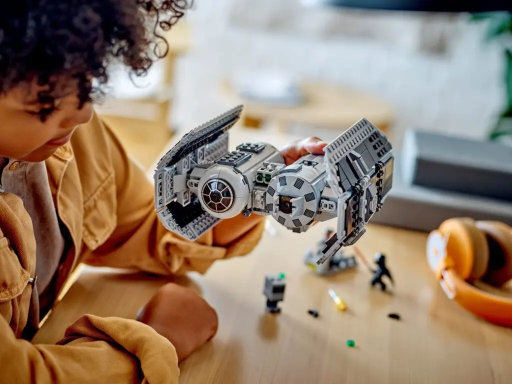Child playing with spaceship model