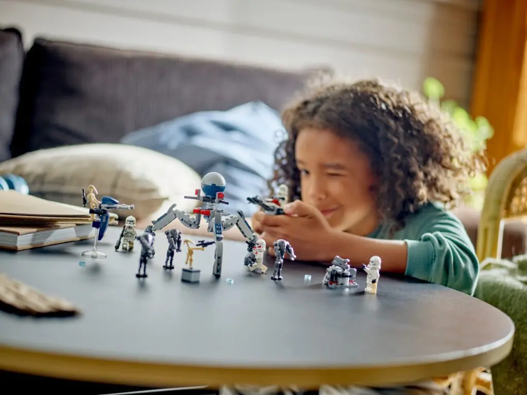 Child playing with toy robots on table