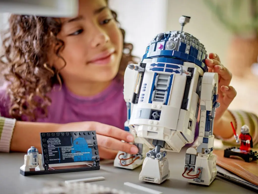 Child playing with R2-D2 model