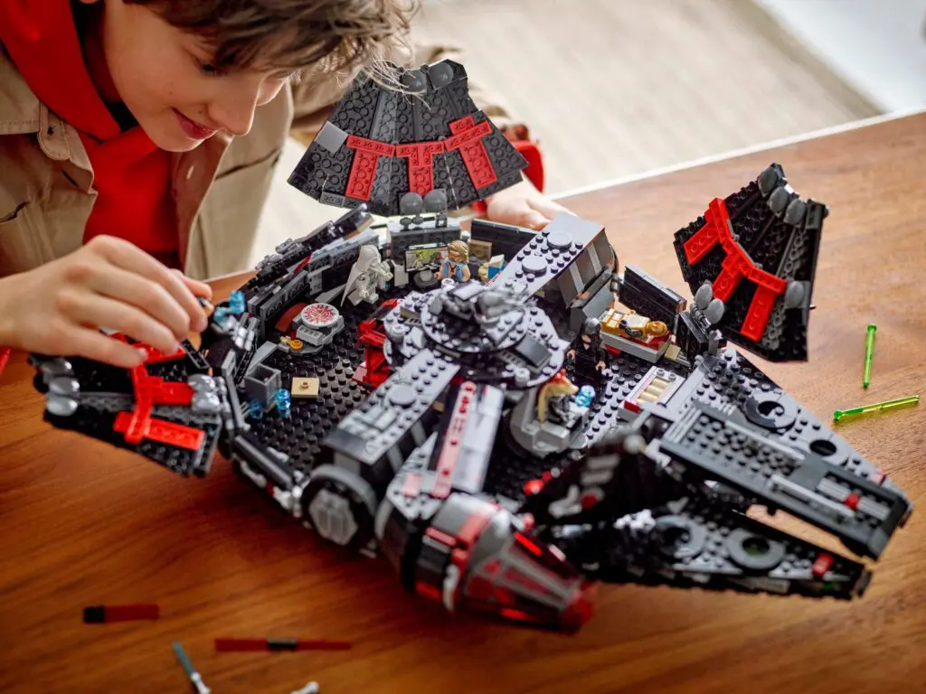 Youngster enjoying creative LEGO construction project.