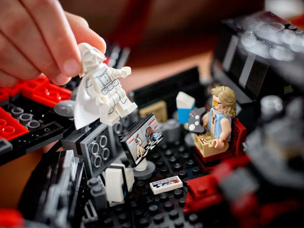 Hand arranging Lego characters on display