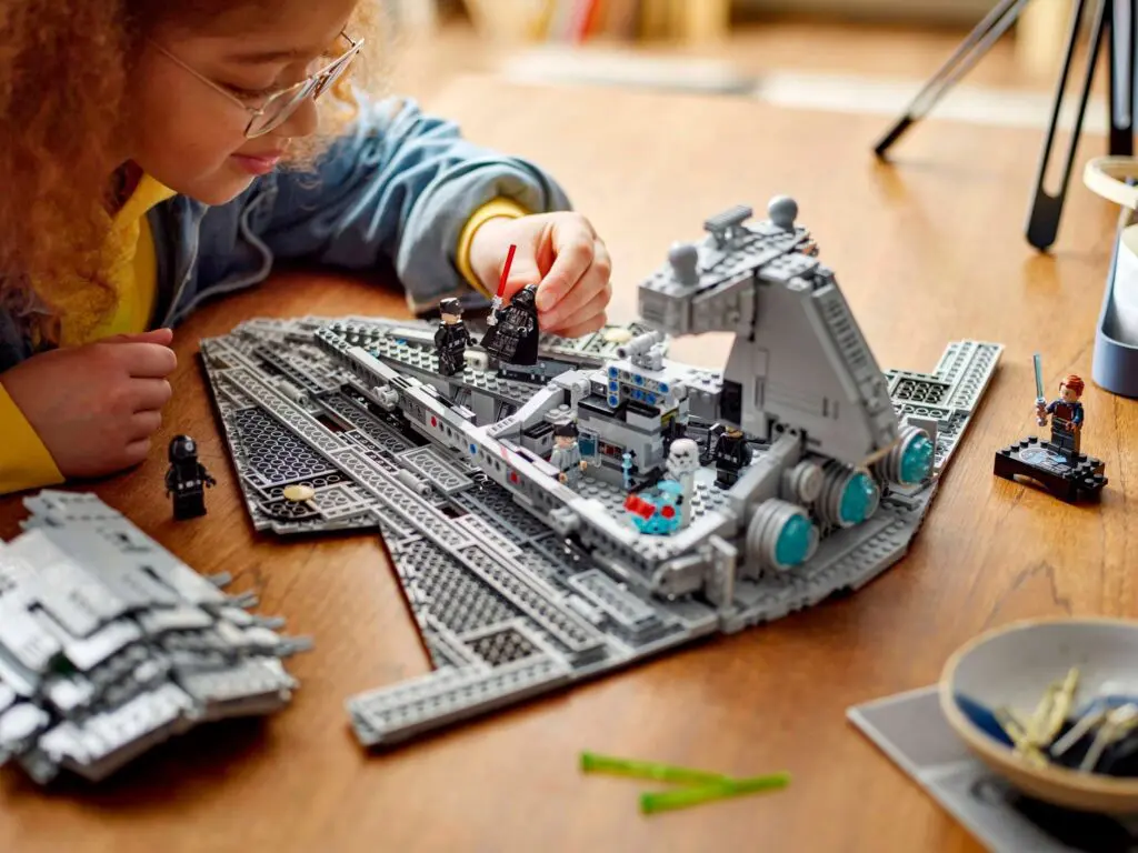 Young girl assembling spaceship toy set