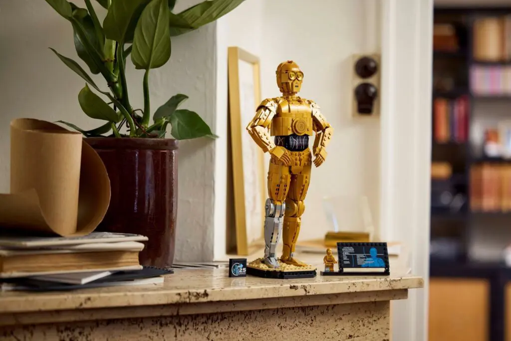 Decorative robot model beside a potted plant