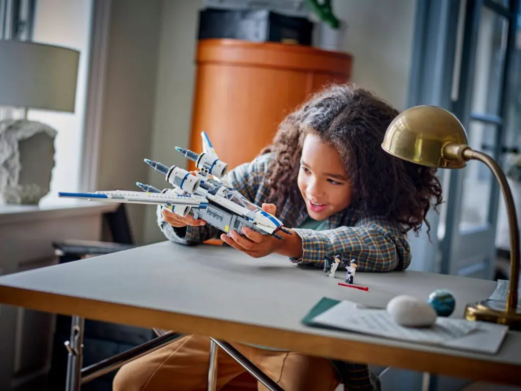 Young girl enjoying a spaceship toy