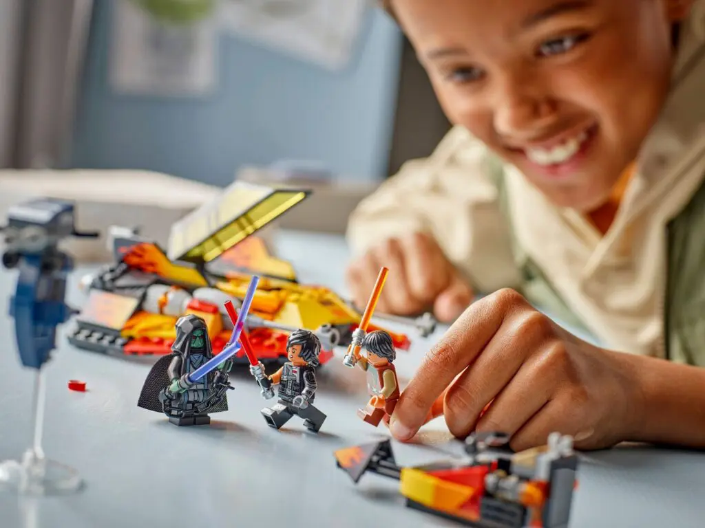 Boy engaged with colorful LEGO playset