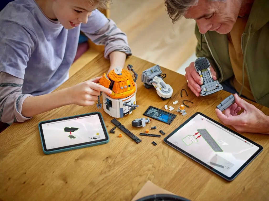 Father and child assembling LEGO spaceship