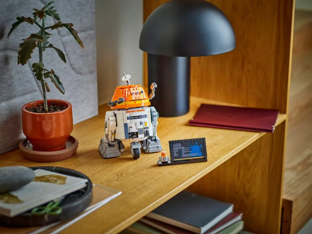 Robot figurine beside potted plant